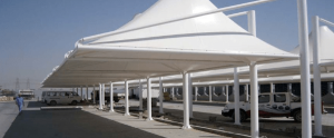 Wave tensile car shades 5 White tensile shade along a building